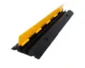 Two-channel cable protector ramp for hire by Glow Power Rental, Dubai UAE — black and yellow rubber cable ramp for two cable runs