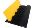 Heavy-duty five-channel cable protector ramp for hire by Glow Power Rental, Dubai UAE — black and yellow rubber cable ramp for multiple cable runs