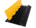 Three-channel cable protector ramp for hire by Glow Power Rental, Dubai UAE — black and yellow rubber cable ramp for three cable runs